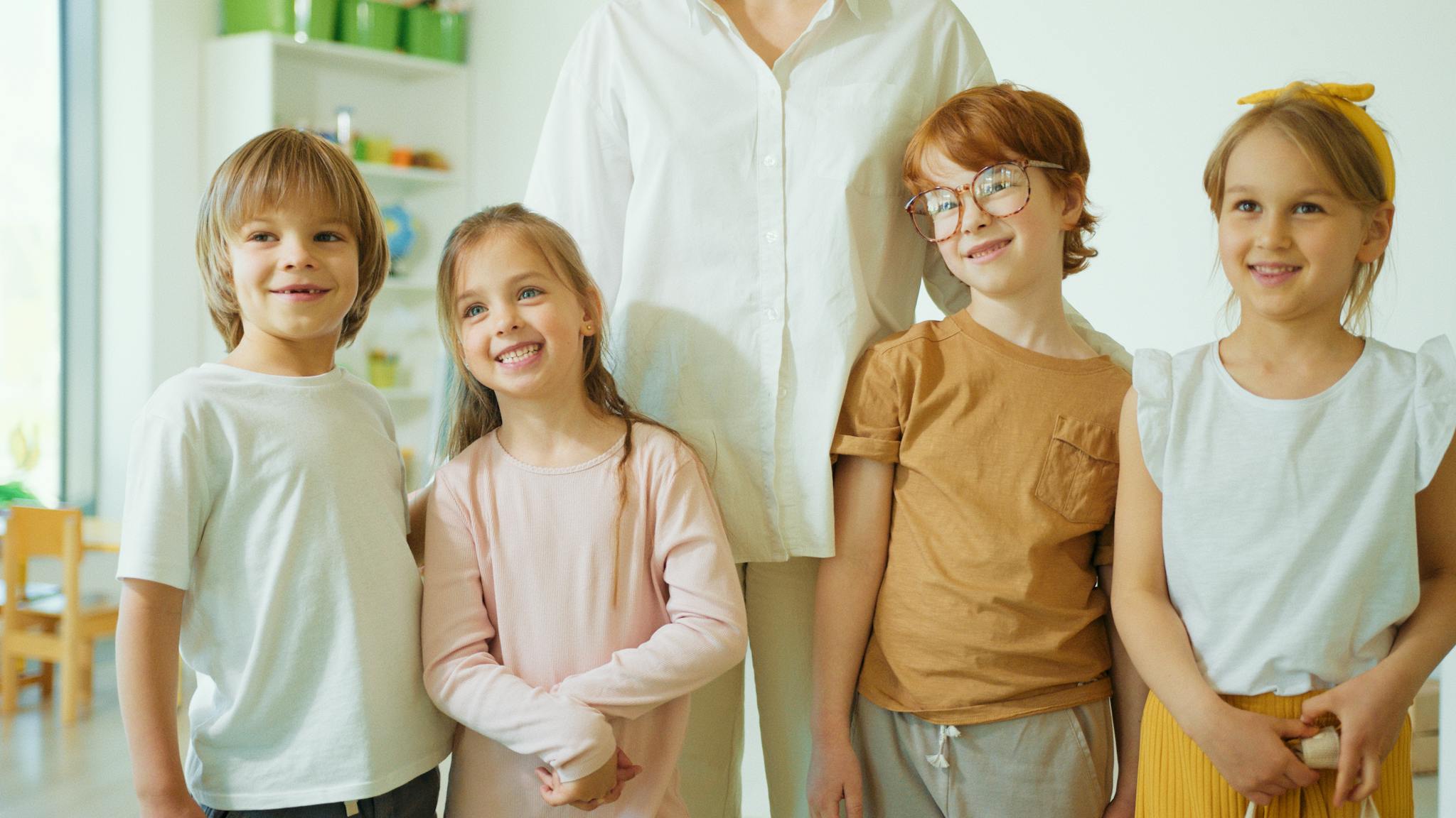 A joyful group of children smiling indoors, showcasing diversity and camaraderie.
