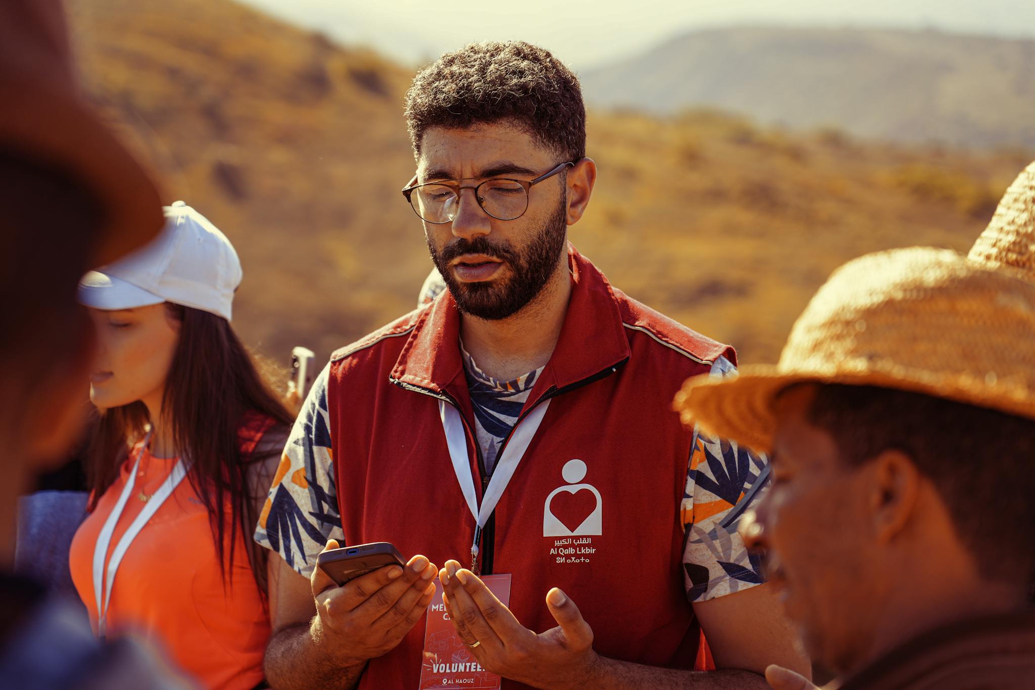 Volunteers gathered outdoors for a community meeting, promoting teamwork and collaboration.